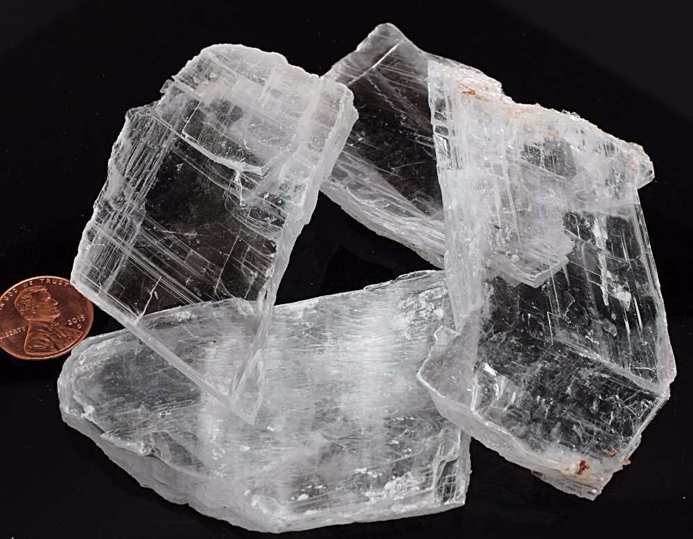Cristal de sélénite translucide posé sur une surface en bois.